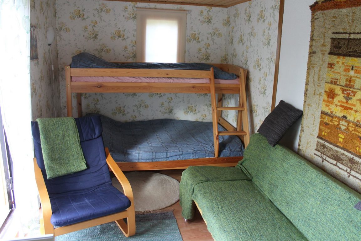 a sitting room with a bunk bed.