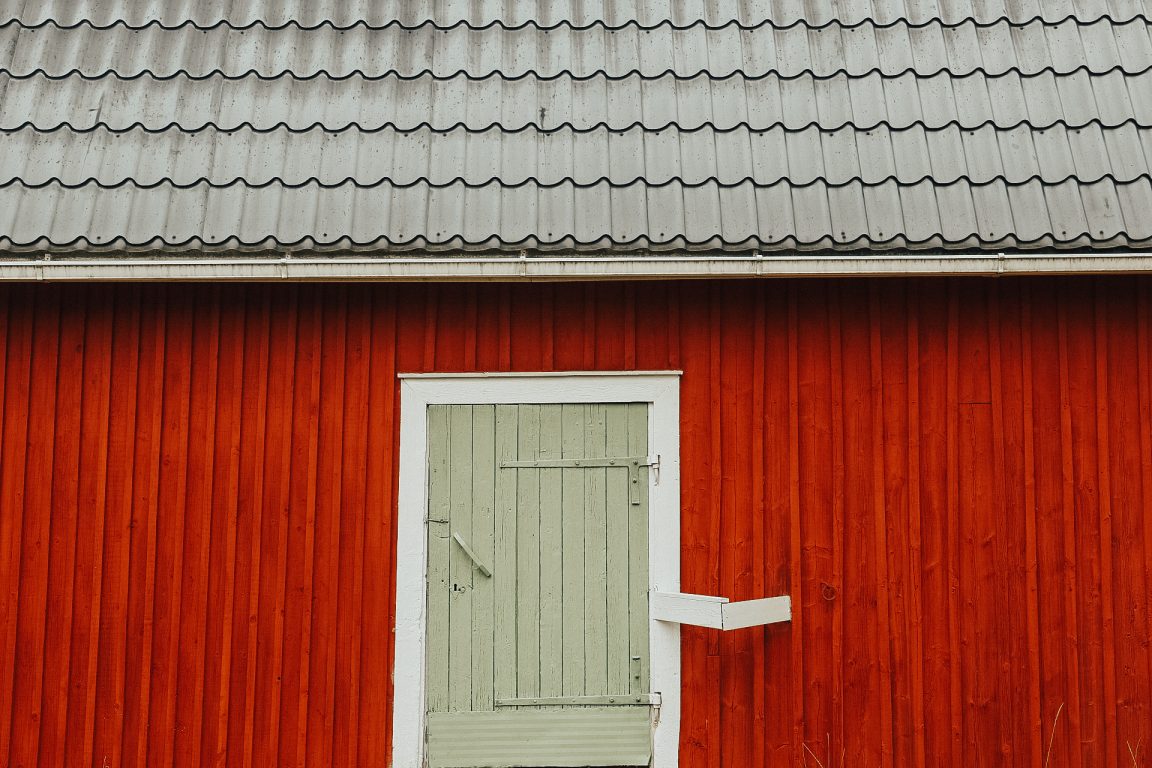 Kullanpuu Farm and red wooden wall. 